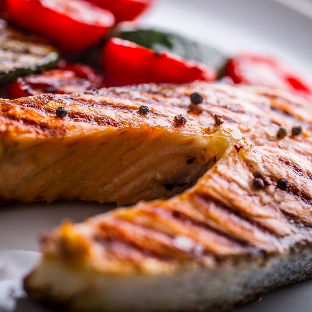 Herby salmon with roasted aubergine, tomatoes, peppers and lentils