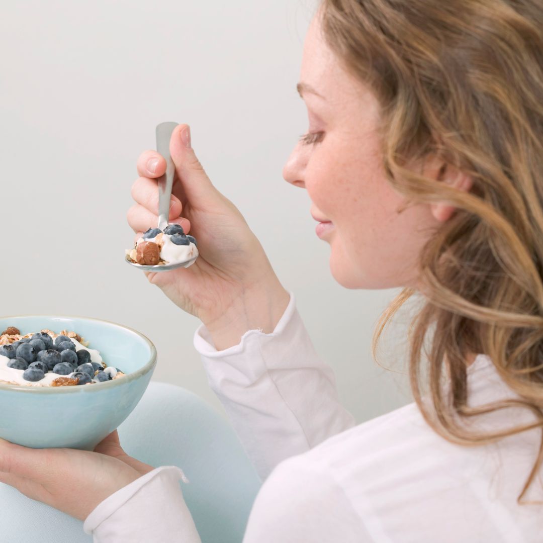 Healthy woman eating a healthy breakfast and thinking about top tips
